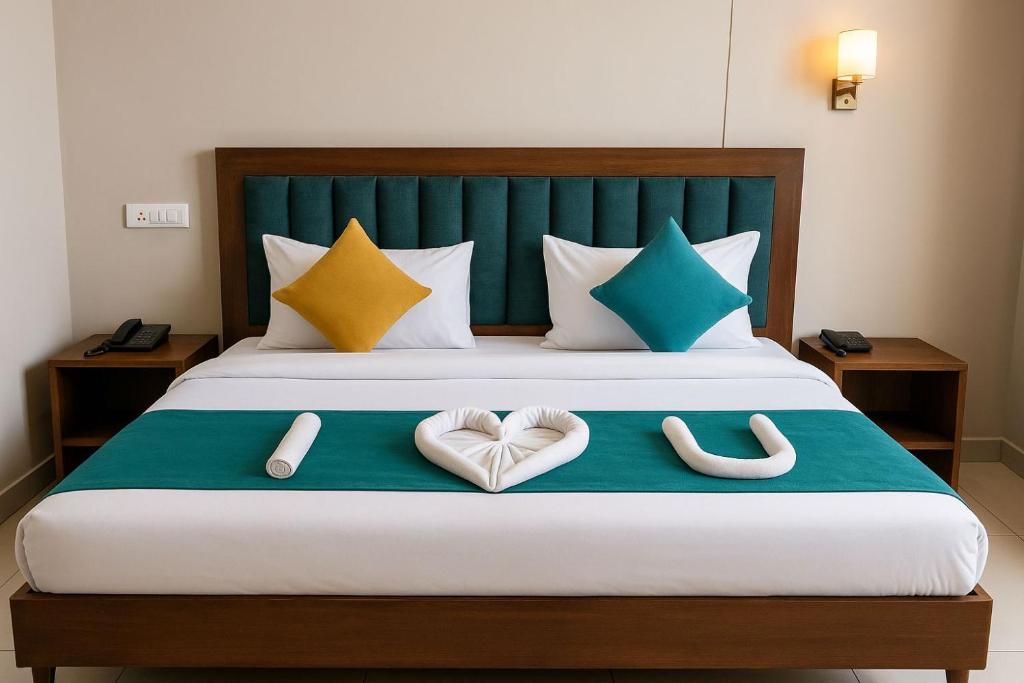 a bedroom with a bed with two hearts on it at Hotel Maria in Dera Bassi