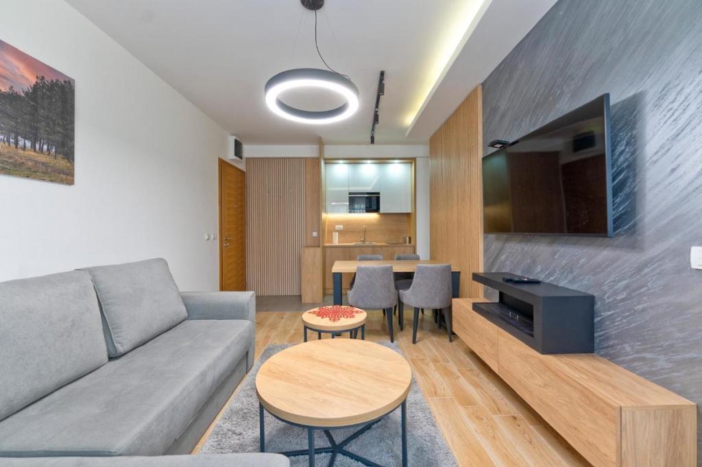 a living room with a couch and a table at Apartman Vida Zlatibor in Zlatibor