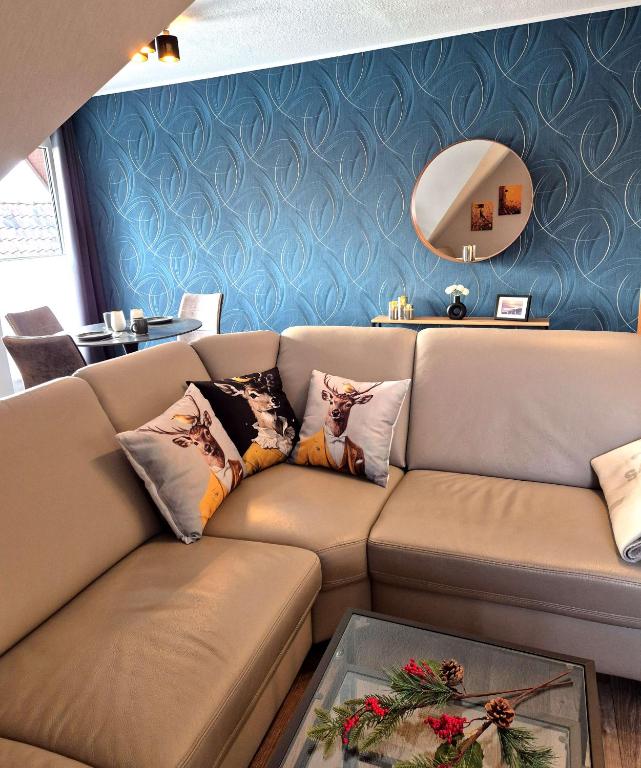 a living room with a couch and a mirror at Ferienwohnung Neckel Hohnstorf in Hohnstorf