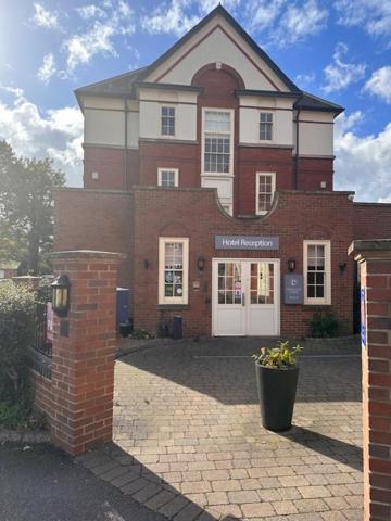 a brick building with a flower pot in front of it at Deincourt Hotel in Newark upon Trent