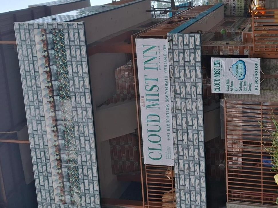 a store with signs on the side of a building at Cloud Mist Inn YERCAUD in Yercaud