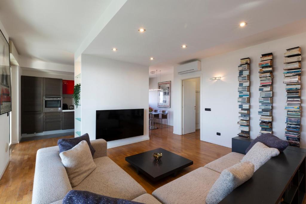 a living room with a couch and a tv at Settimo Cielo - San Cristoforo in Milan