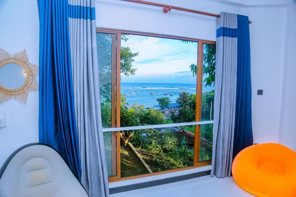 a room with a large window with a view of the ocean at Cozy 1BR Villa in Weligama Panoramic Sea View in Weligama