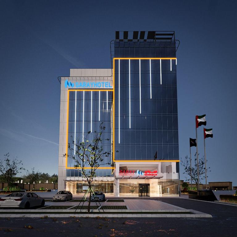 a large building with a sign on the front of it at Saray Deluxe Hotel Apartments in Abu Dhabi