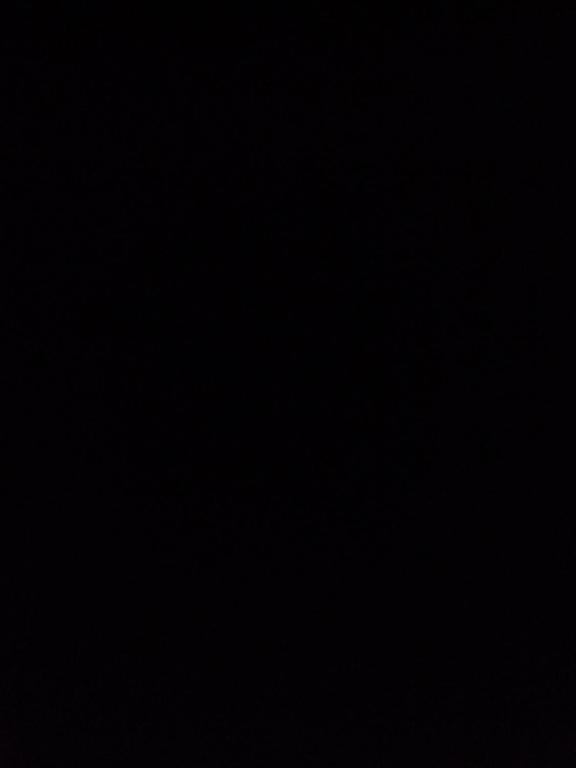 a dark room with a black background at Homestay in Dublin