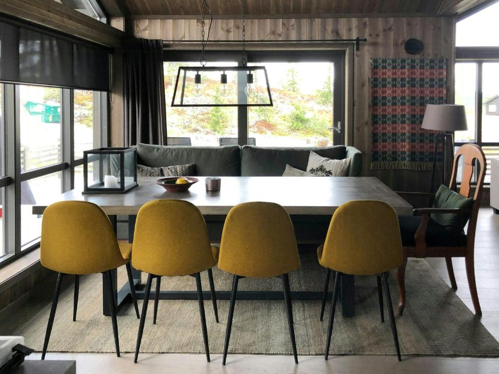 a dining room with a table and four chairs at Modern Cabin With Views Of Skeikampen in Svingvoll