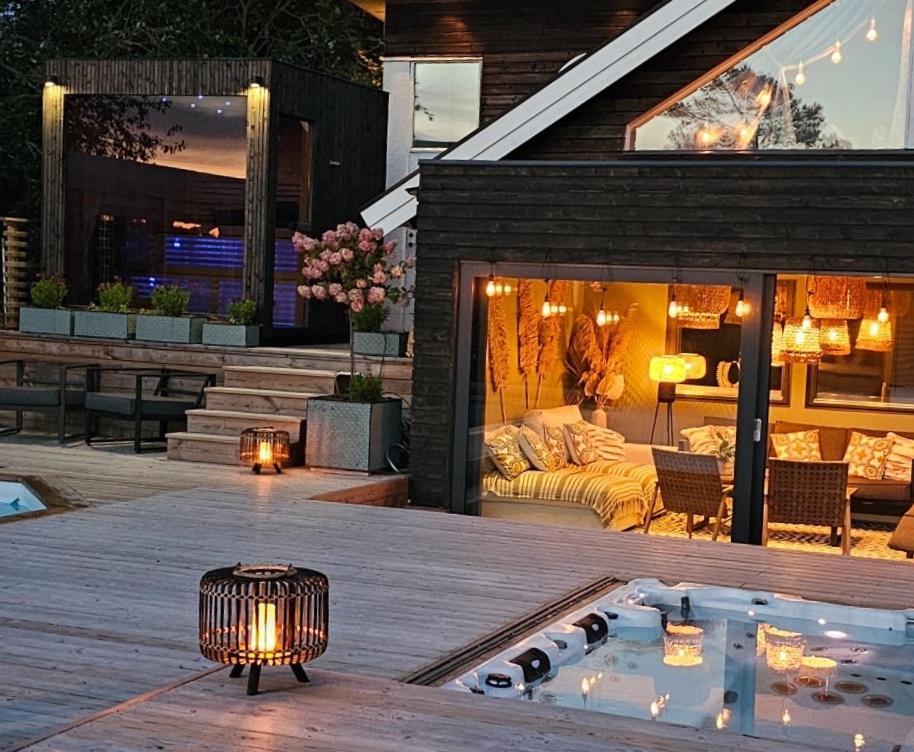 a backyard with a hot tub and a house at Privat Spirit Spa Villa in Vallentuna