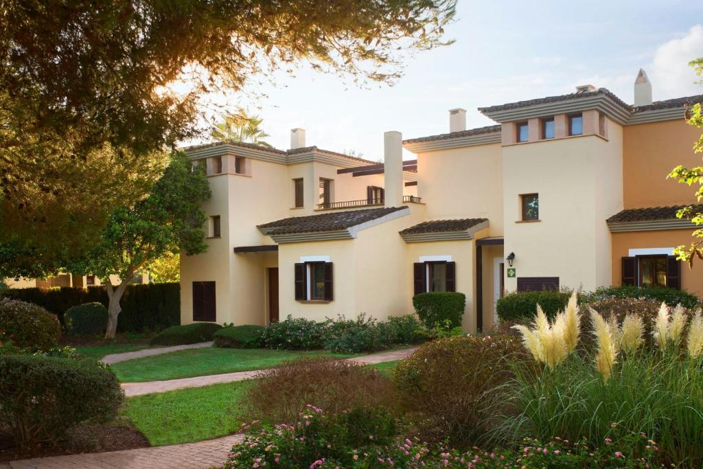 eine Außenansicht eines Hauses mit Garten in der Unterkunft Marriott’s Club Son Antem in Llucmajor