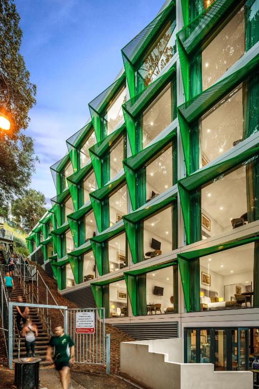 a green building with people walking in front of it at Quest Mounts Bay Road in Perth
