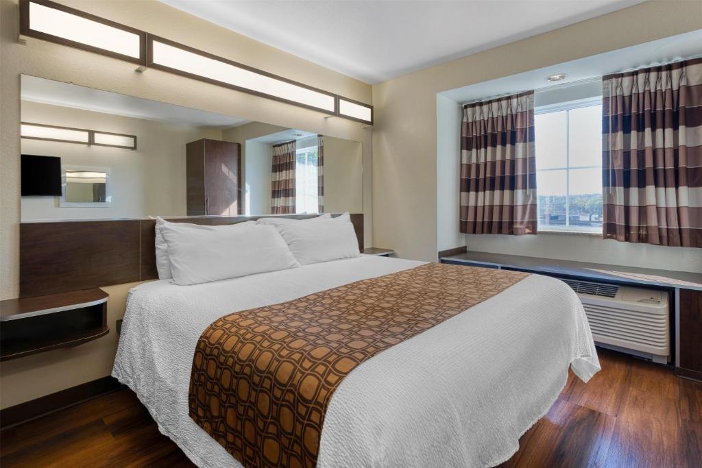 a hotel room with a bed and a window at SureStay Plus Hotel by Best Western Buckhannon in Buckhannon