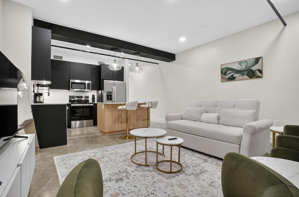 a living room with a couch and a table at Downtown Tulsa Beacon Getaway in Tulsa