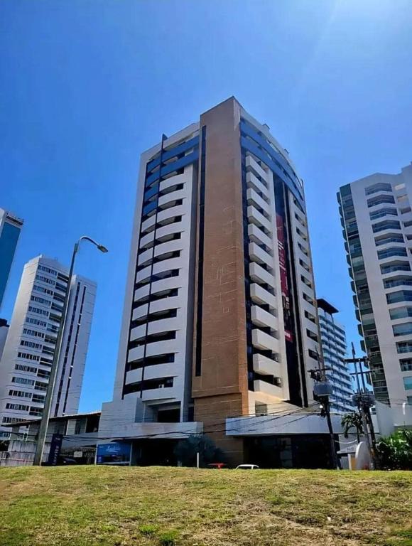 a tall building in a city with tall buildings at Flat Biarritz - Praia Litorânea in São Luís