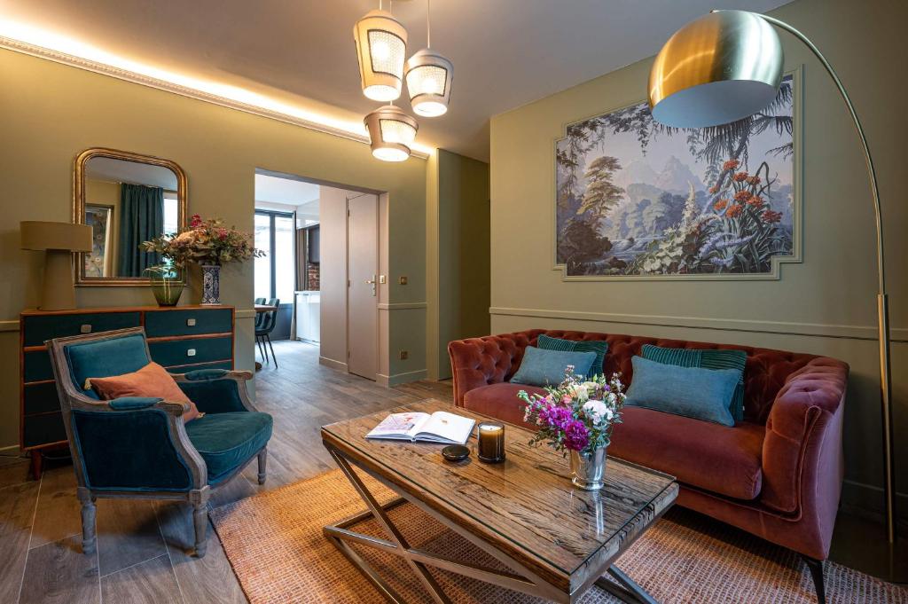 a living room with a couch and a table at My Boudoir in Paris
