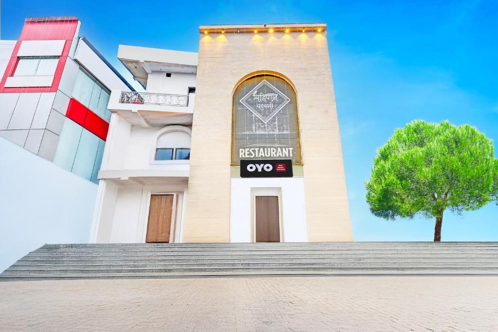 a building with a tree in front of it at The Krishna's Bliss in Ghaziabad