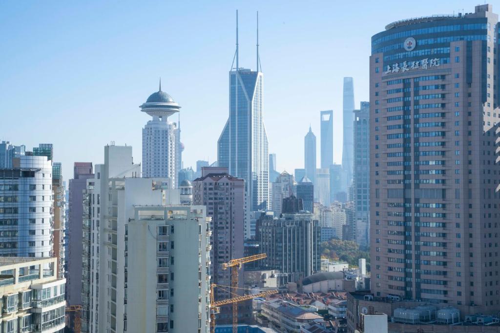 a view of a city with tall buildings at Yi Du Home with City View - Family Suite 500m to Nanjing West Rd Near People's Square -Credit Cards Accepted in Shanghai