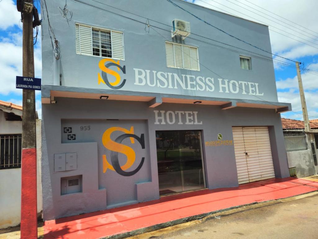a building with a s business hotel on a street at Suite Campina - Business Hotel in Campina do Monte Alegre