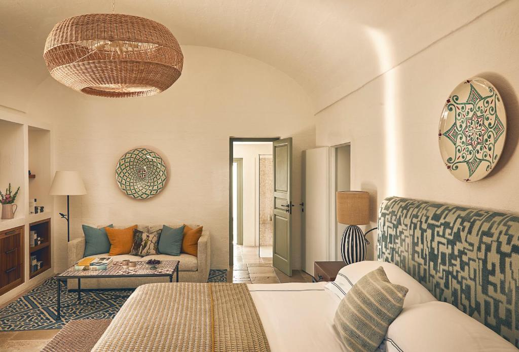 a living room with a couch and a table at Rocco Forte Masseria Torre Maizza in Savelletri di Fasano