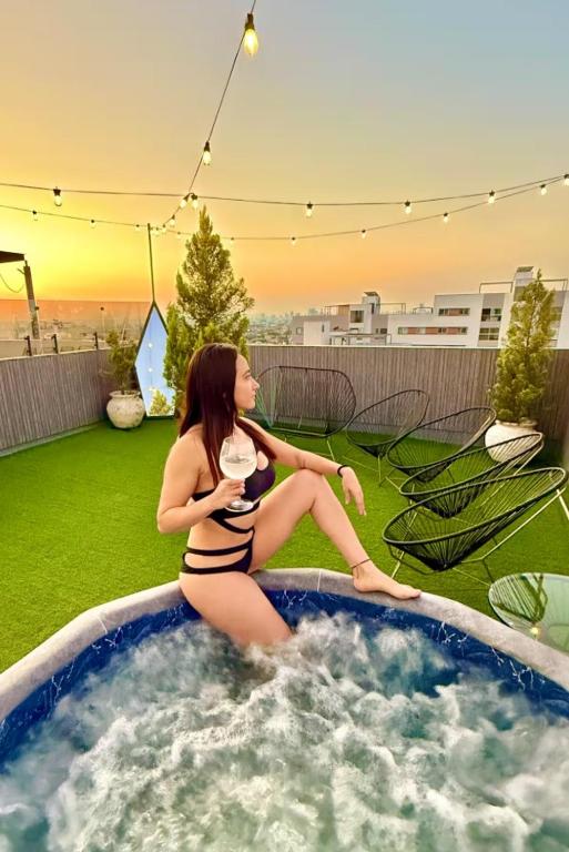 a woman in a bikini sitting in a hot tub at Chalet Saint Lawrence GDL in Guadalajara
