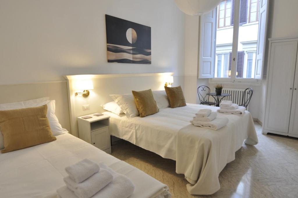 a bedroom with two beds with towels on them at Hotel Canada in Florence