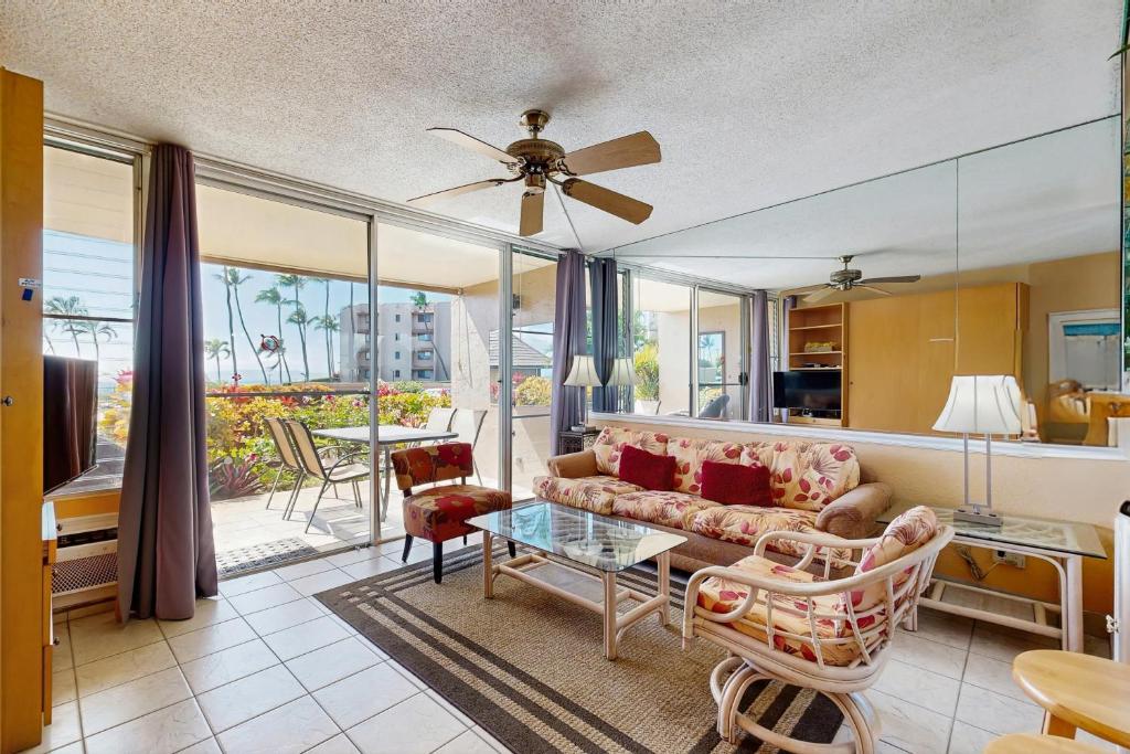 a living room with a couch and a table at Island Sands Resort 103 in Maalaea