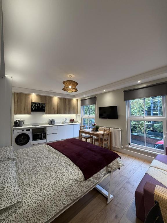 ein Schlafzimmer mit einem großen Bett und eine Küche in der Unterkunft KAStay london in London