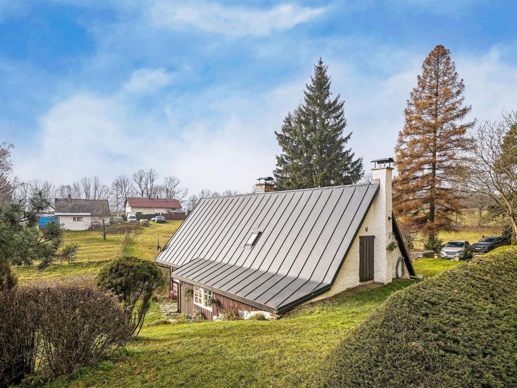 an old house with a metal roof on a field at Holiday Home Holiday Hill by Interhome in Lauterwasser