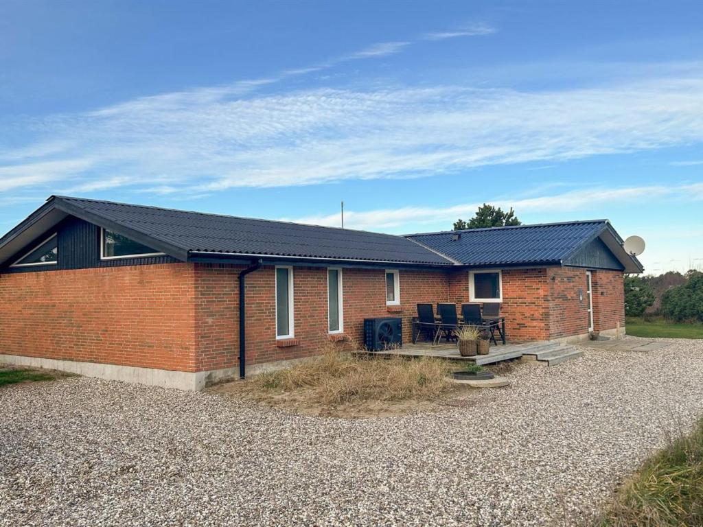 a brick house with solar panels on it at Holiday Home Bela - from the sea by Interhome in Ringkøbing