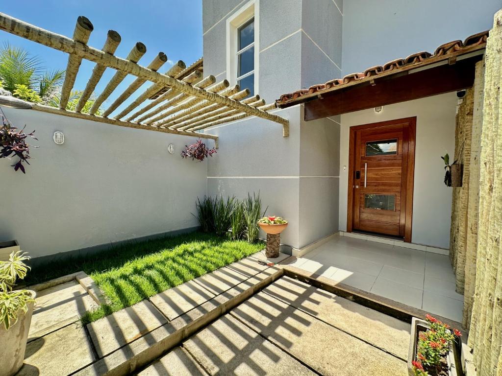 a patio of a home with a pergola at Mar de Corais Hospedagem in Serra