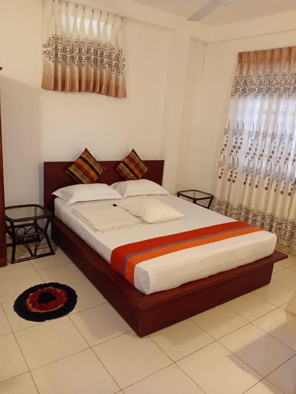 a bedroom with a large bed in a room at N S Apartment in Mount Lavinia