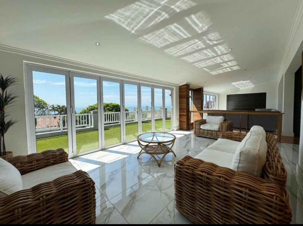 Chamane Place في ديربان: غرفة معيشة مع كنبتين وشرفة