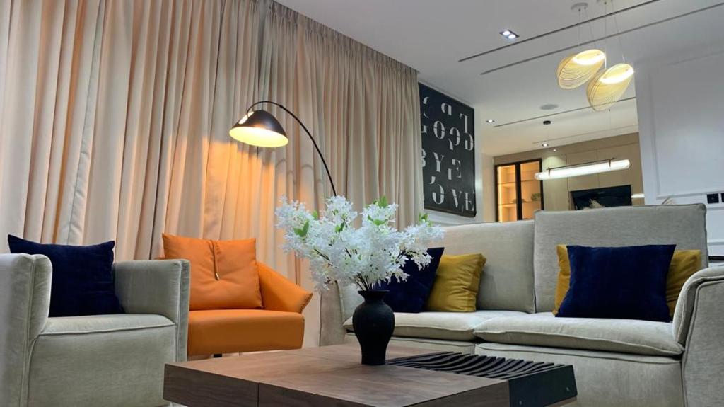 a living room with two couches and a coffee table at Aklass Apartments in Lekki