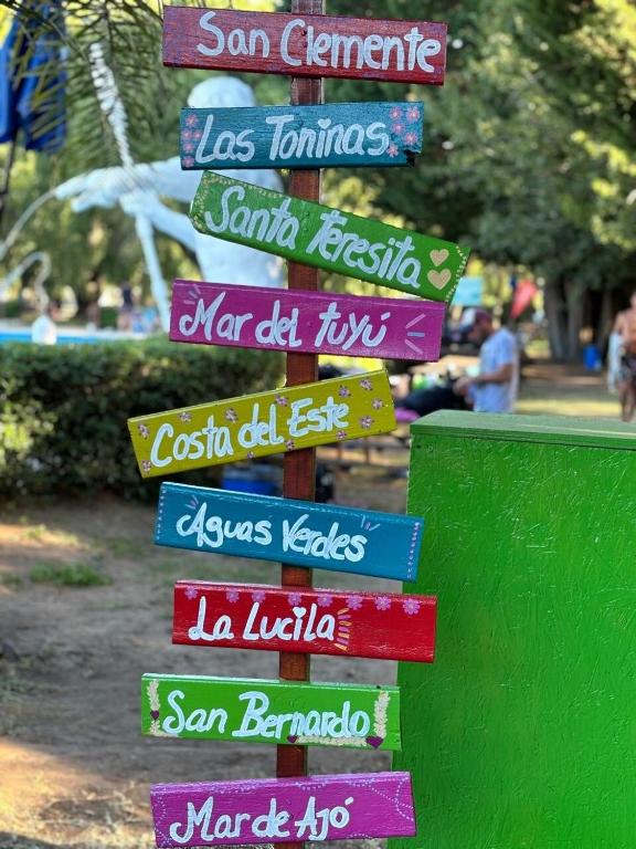 a group of signs on a pole in a park at Beach House and Nature in Aguas Verdes