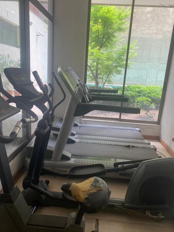 a gym with two exercise bikes and a window at Monica Canales in Santiago
