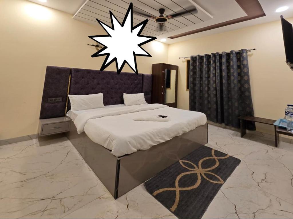 a bedroom with a bed with a star on the wall at Prabh palace in Ayodhya
