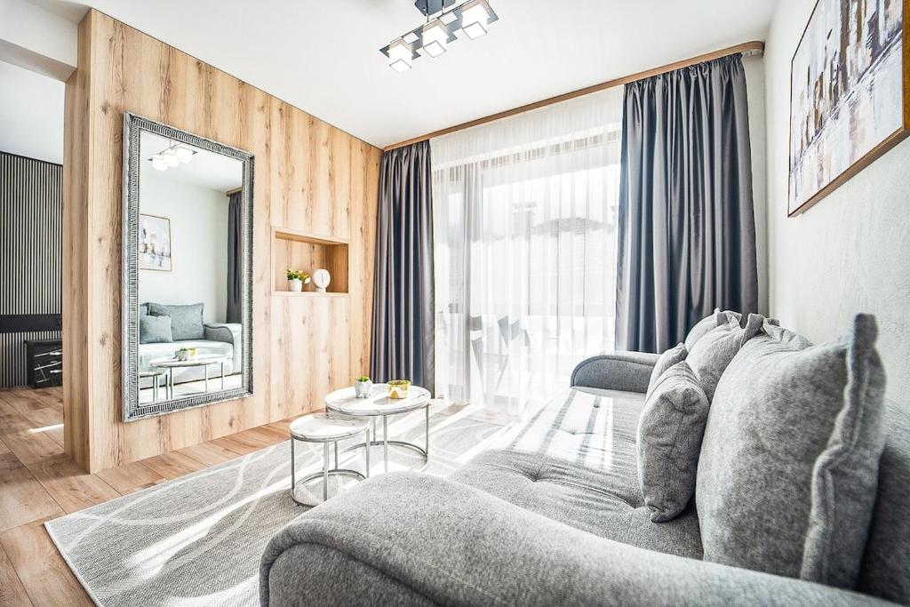 a living room with a couch and a table at Best Central Lux Studio in Bansko