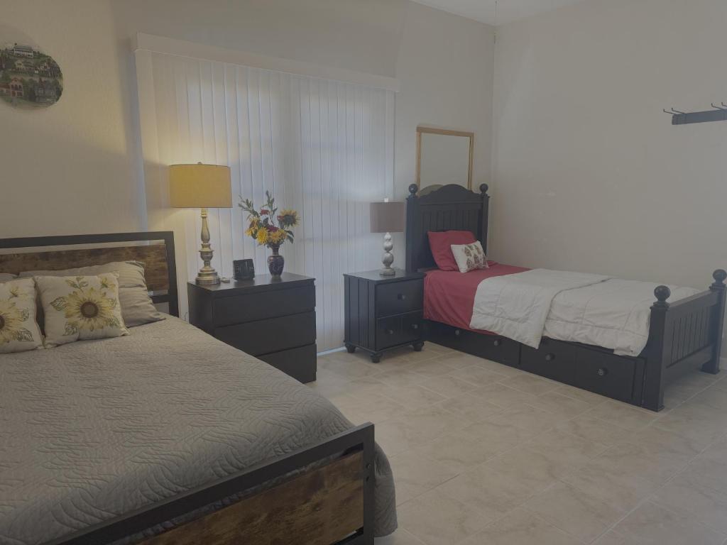 a bedroom with two beds and a mirror at Cozy 2-Bed Guest Room Convenient Location in Tracy