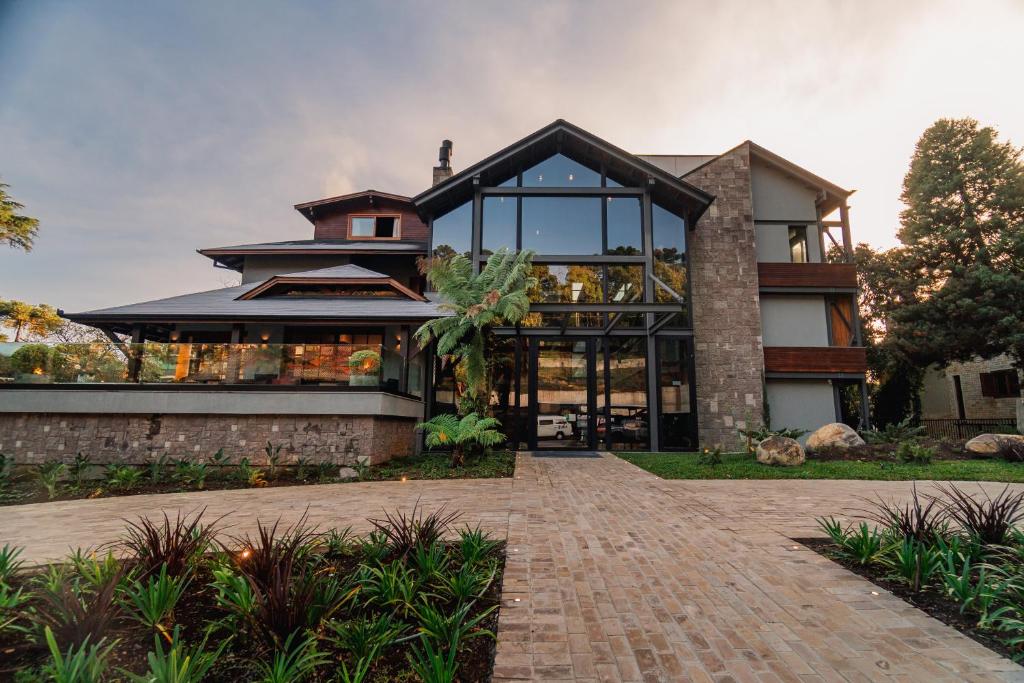 a large house with a brick walkway in front of it at 249 DESIGN HOTEL in Gramado