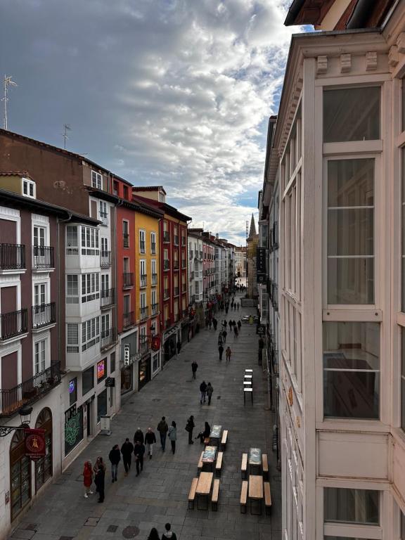 a group of people walking down a street with benches at Atuaire Home Centro Histórico con vistas rozando la Catedral con Parking Incluido in Burgos