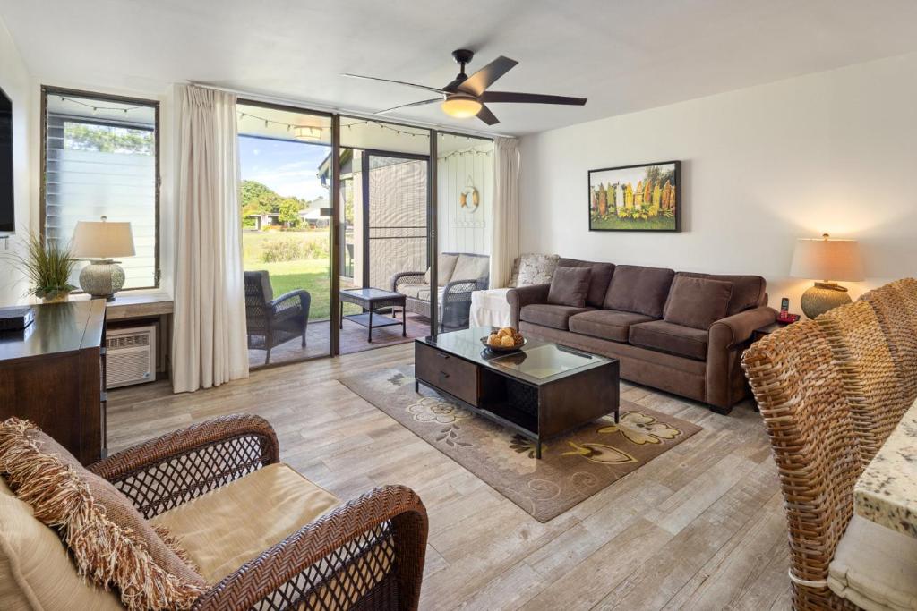 a living room with a couch and chairs at Tee and Sea Getaway ay Turtle Bay in Kahuku