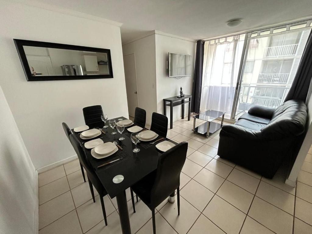 a living room with a black table and chairs at Departamento elsa ramitez in Ovalle
