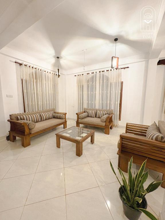 a living room with couches and a coffee table at Villas by DIMA in Galle