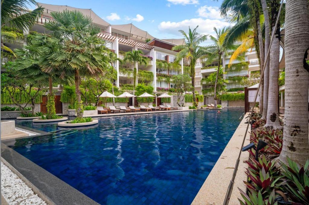 an image of a swimming pool at a resort at Stylish 2BR Resort Condo with Seaview Surin in Phuket