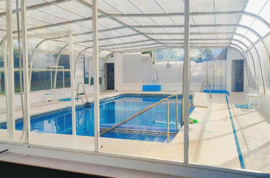an indoor swimming pool with a large building at Laguna Beach 15 Primera linea de Playa in Morche