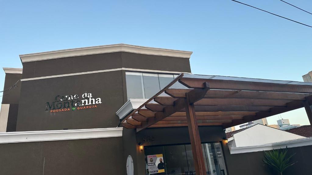a building with a sign on the side of it at Pousada Canto da Montanha in Guarujá