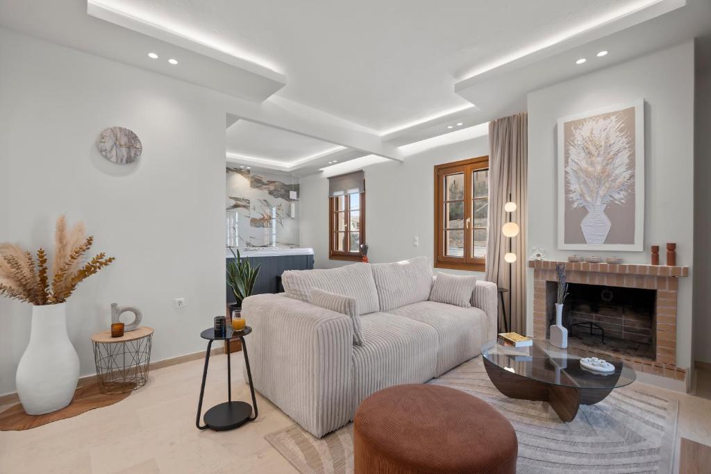 a living room with a couch and a fireplace at Pnoe Luxe Apartment & Spa, Naxos Town in Naxos Chora