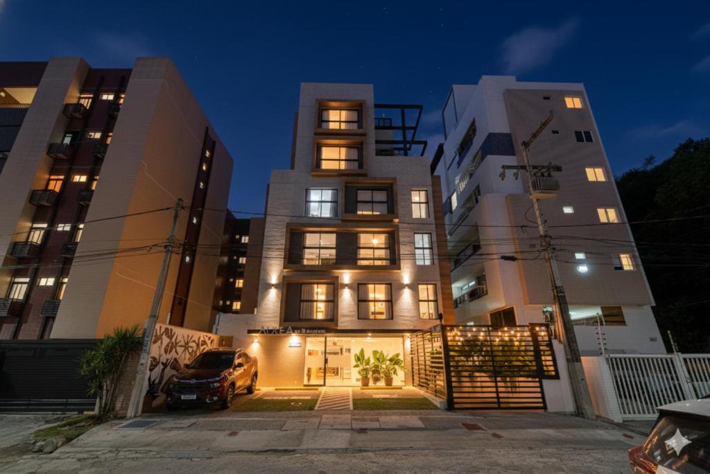 a building with a car parked in front of it at Aurea Cabo Branco Beach in João Pessoa