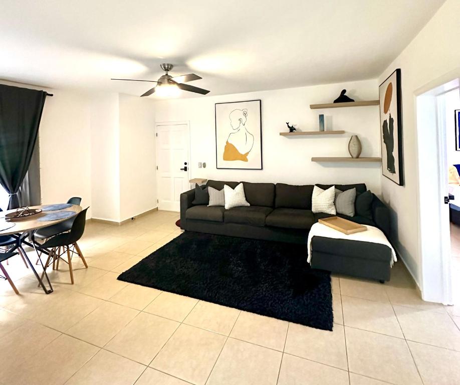 a living room with a couch and a table at Luxury modern retreat- next to the beach in Punta Cana
