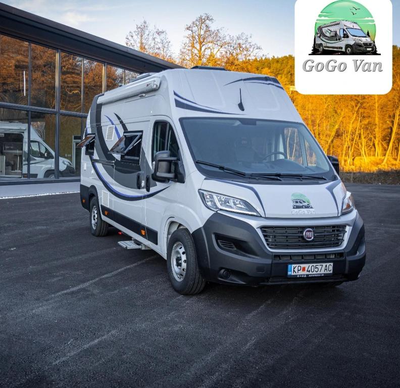 a white van parked in a parking lot at Gogo vans home on wheels in Kriva Palanka