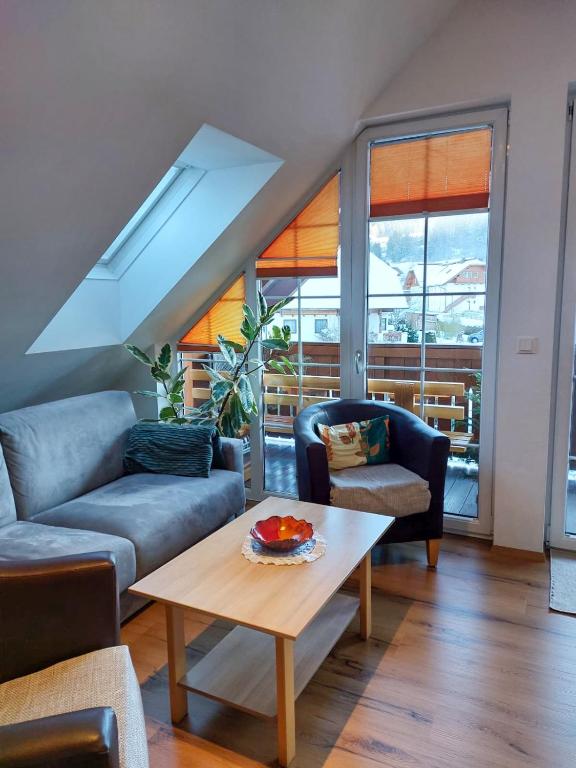 a living room with a couch and a table at Penthouse Aineckblick in Sankt Margarethen im Lungau