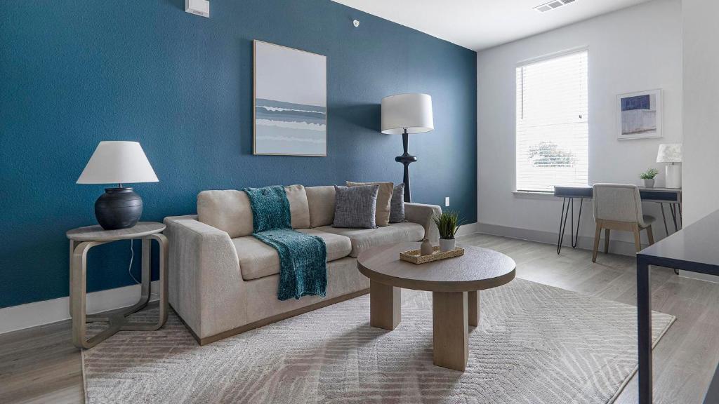 a living room with a couch and a table at Landing Modern 1BD Pool Gym in Austin